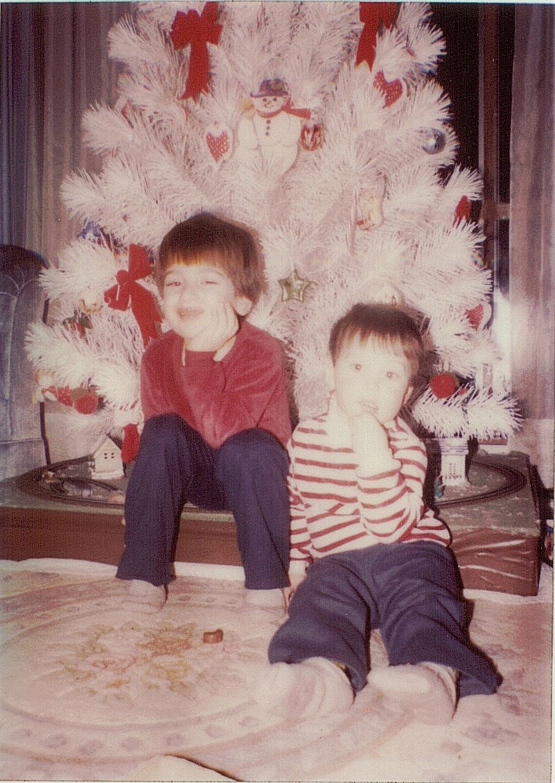 Dave and Mike by a white Christmas tree.